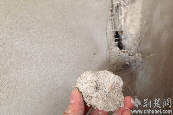 　记者用手一抓就能抓下一大块墙面填充物。中建三局总承包公司的文总工程师依据经验判断，该楼盘内墙保温层为无机玻化微珠保温砂浆和胶粉聚苯颗粒保温浆料。图片来源：荆楚网