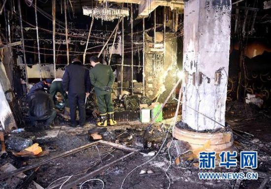 12月15日，公安和消防部门的工作人员在火灾现场勘查。 新华社记者 李安 摄