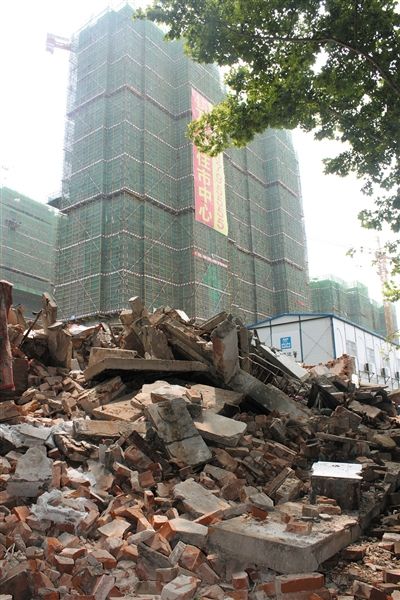 7月21日，麻伟玲、胡凯母子居住的6号楼现已被全部拆除。废墟后为名门地产公司建设中的回迁新房。