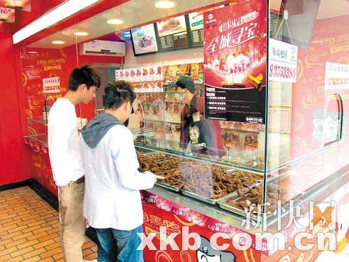 　　■两个小伙子在周黑鸭专卖店购买鸭脖。