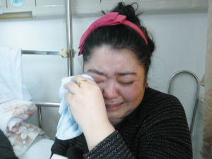 居拉提的妻子热孜万古丽在一旁已泣不成声。