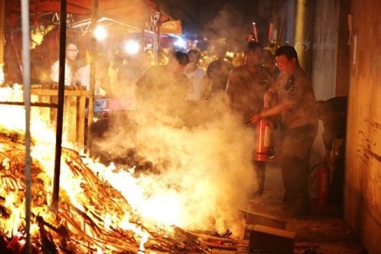 零时30分左右，香火的火苗四处飞窜，热浪滚滚，难以靠近的陪读家长仍在不远处下跪祈福。
