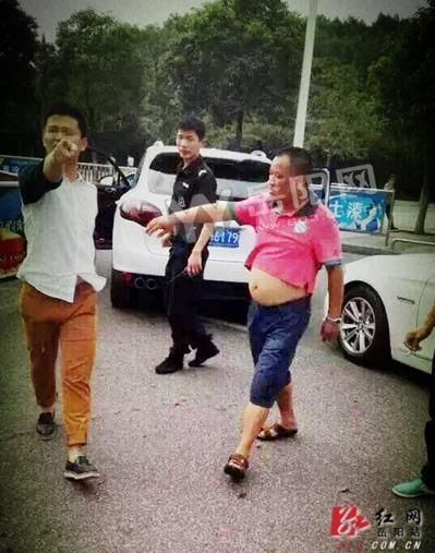 身穿白色上衣者为打人男子 