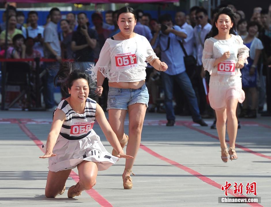 一名女子脚穿高跟鞋赛跑不幸摔倒. 韦亮 摄