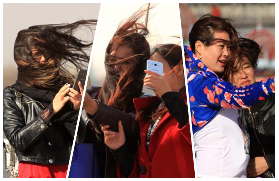 哈尔滨大风六七级 头发凌乱也要自拍