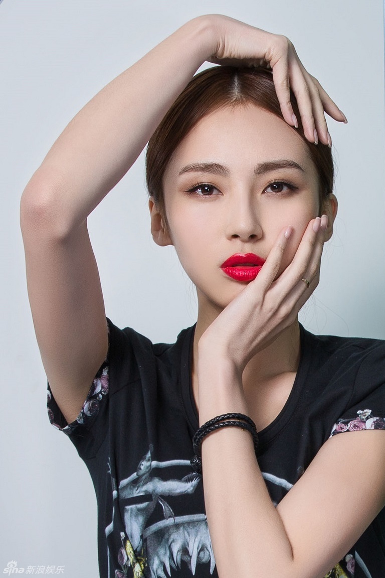 路晨一袭简约时尚的黑色装扮,t恤的图纹设计潮味十足,烈焰红唇展露着