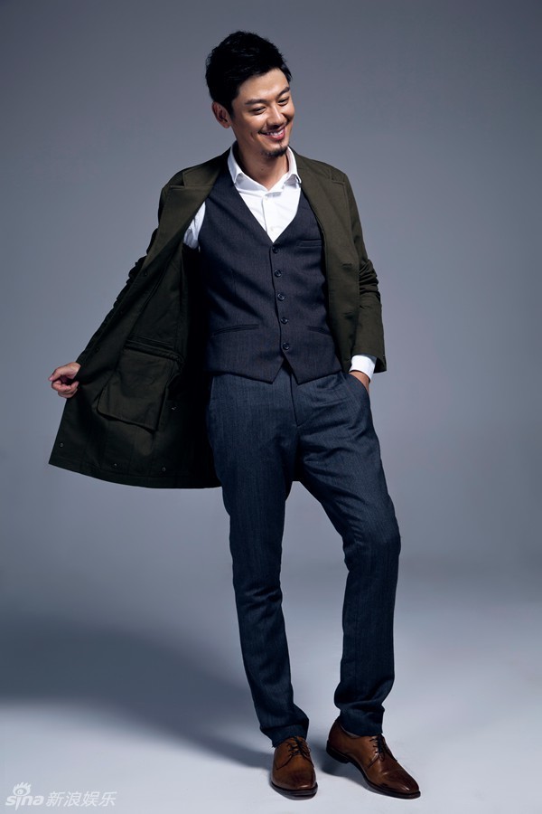 写真中,芦芳生大胆挑战蓝色格纹西装,手拿复古礼帽,眼神时而冷峻,时而