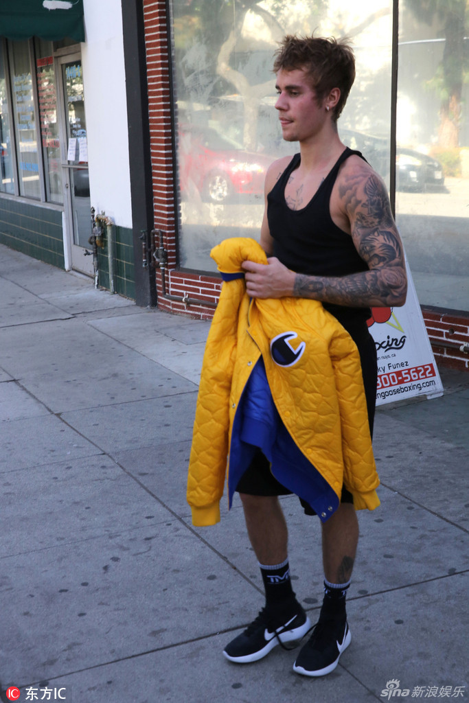 运动短裤和运动鞋搭配一件黄色夹克,时不时吐舌卖个萌,一身健硕肌肉很