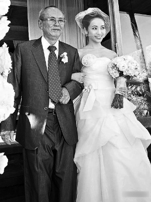 　　侯佩岑(右)由“PaPa”邱嘉雄牵着步入结婚礼堂。