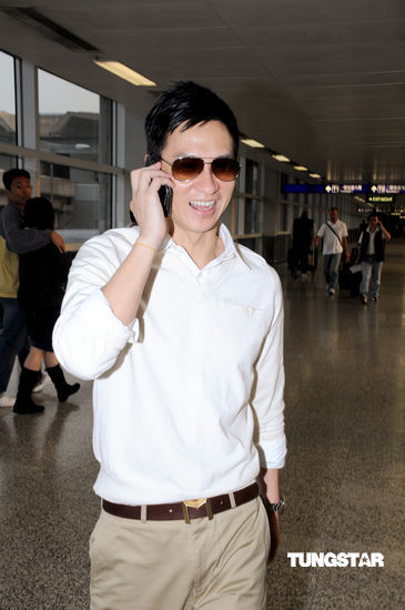 图文:金马影帝张家辉返港--下飞机兴奋打电话