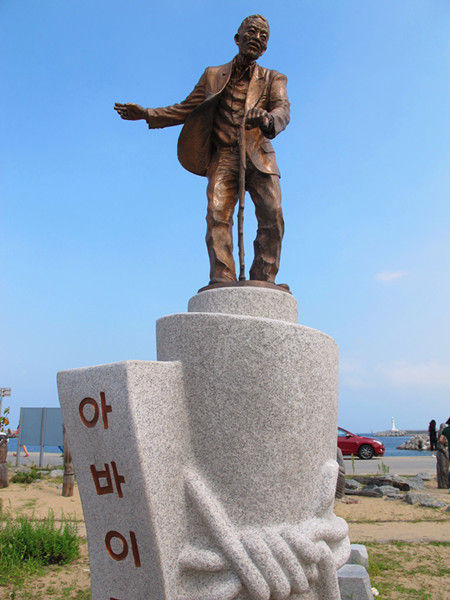 村外象征阿爸伊村庄的雕像。一位佝偻慈爱的父亲形象，似乎代表了初代村民对故乡的依恋与无奈。