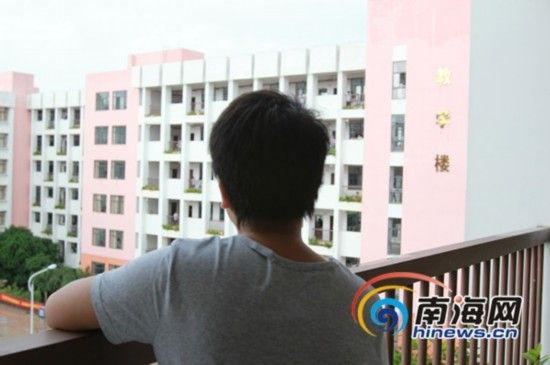 王女士的儿子王某无奈地看着学校教学大楼