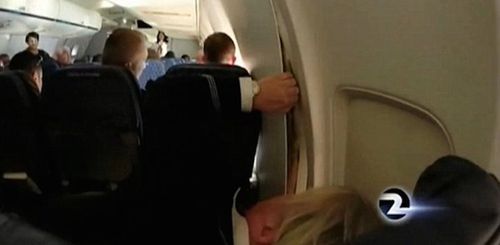 空乘在检查“伤势”（电视新闻截图）