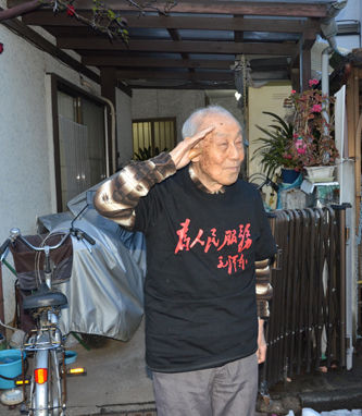 身穿毛主席题词“为人民服务”T恤敬军礼的小林宽澄 