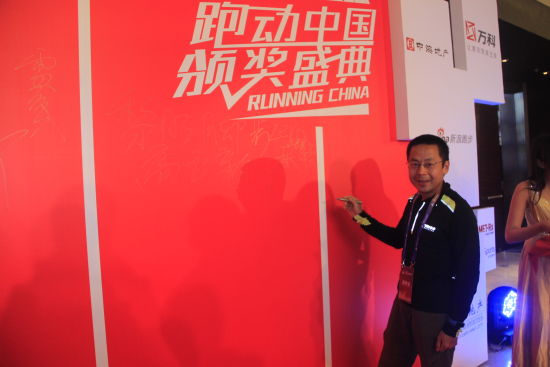 图为获奖者王晓林在签字墙前留影。