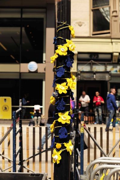 两年前波士顿马拉松爆炸点附近的电线杆上，可以看到市民缀上的绢花。