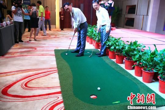 新闻发布会上，中韩两国代表现场演示高尔夫“推杆进洞”。